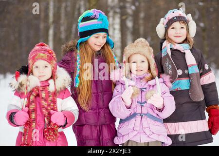 Quattro ragazze, due più grandi e due più giovani, si trovano insieme nel parco invernale Foto Stock