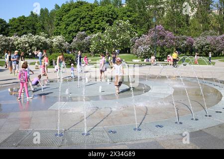 MOSCA - 25 MAGGIO 2015: Persone intorno alla fontana secca nel giardino lilla con arbusti fioriti a Mosca Foto Stock