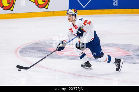 EHC Red Bull München Verteidiger #58 Ryan McKiernan ist, während dem Spiel der Champions Hockey League gegen EV Zug in der Bossard Arena, mit dem Puck Foto Stock