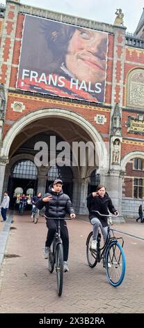 AMSTERDAM, NETHLANDS - 25 APRILE 2024 - le persone viaggiano in bicicletta in una strada di Amsterdam, Paesi Bassi, 25 aprile 2024. Foto Stock