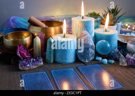 Dire la fortuna. Natura morta mistica con candele, cristalli e Tarocchi Foto Stock