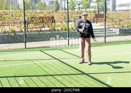 Ucraina Kiev, 20 aprile 2024. bella ragazza felice che pratica lo sport del paddle sul campo da paddle Foto Stock