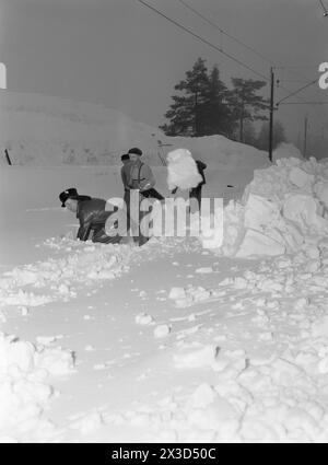 Effettivo 05- 1951: Norvegia meridionale coperta di neve. Lungo le strade, i bordi dell'aratro sono alti quattro cinque metri, la neve è così alta che si può facilmente uscire dal secondo piano e le persone devono costantemente salire sui tetti per liberare la neve da lì. Foto: Arne Kjus / Aktuell / NTB ***la foto non viene elaborata*** il testo dell'immagine viene tradotto automaticamente Foto Stock