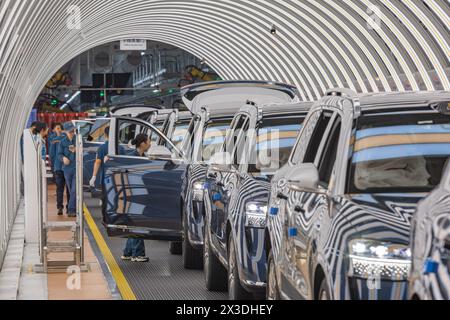 (240426) -- PECHINO, 26 aprile 2024 (Xinhua) -- i lavoratori controllano la qualità dei nuovi veicoli energetici in una fabbrica intelligente del produttore cinese di veicoli Seres Group a Liangjiang New area, municipalità di Chongqing, 25 aprile 2024. Con una crescente domanda di soluzioni di energia pulita per combattere il cambiamento climatico, il panorama globale indica la necessità urgente di ampliare le capacità di produzione piuttosto che di un eccesso. Secondo le proiezioni dell'Agenzia internazionale dell'energia, si prevede che la domanda di nuovi veicoli energetici aumenterà vertiginosamente, raggiungendo i 45 milioni entro il 2030, 4,5 volte quella di Foto Stock