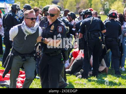 Bloomington, Stati Uniti. 25 aprile 2024. Dozzine di persone vengono arrestate dalla squadra antisommossa della polizia di Stato dell'Indiana durante una protesta filo-palestinese nel campus. I manifestanti avevano allestito un campo tenda a Dunn Meadow alle 11 del mattino e la polizia ha detto loro di abbattere le tende, o avrebbero sgomberato l'area con la forza e arrestato chiunque non se ne fosse andato. Tutti i manifestanti arrestati, compresi i professori, sono stati banditi dal campus dell'Indiana University per un anno. (Foto di Jeremy Hogan/SOPA Images/Sipa USA) credito: SIPA USA/Alamy Live News Foto Stock