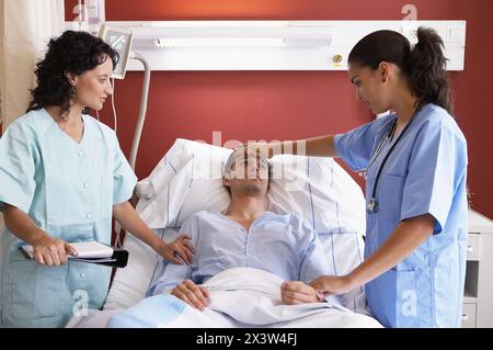Medici e pazienti in ospedalizzazione Foto Stock