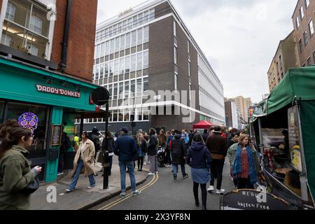 Leather Lane, una strada nel centro di Londra con molte bancarelle che offrono cibo di strada ogni giorno feriale. Papà Donkey all'angolo è un ristorante messicano. Foto Stock