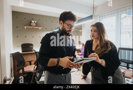 Colleghi aziendali che discutono strategie di progetto con un lavoro di squadra mirato in un ufficio moderno Foto Stock