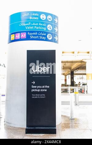 Zona di prelievo dall'Uber e segnaletica direzionale all'aeroporto internazionale di Dubai (DXB), Emirati Arabi Uniti. Foto Stock