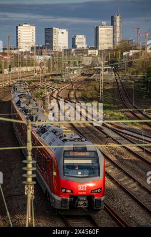 Treno sui binari ad ovest della stazione principale di Essen, skyline del centro città, treno regionale espresso, NRW, Germania, Foto Stock