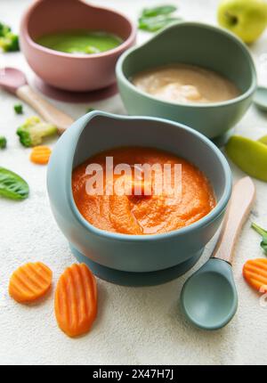 Alimenti sani per bambini in ciotole. Varie ciotole di purea di frutta e verdura, vista dall'alto Foto Stock