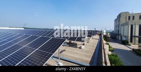 Array di pannelli solari sul tetto di un edificio industriale sotto Clear Blue Sky /Dongying China Foto Stock