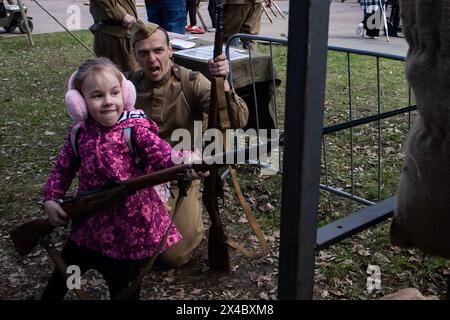 San Pietroburgo, Russia. 1° maggio 2024. Un uomo vestito con un'uniforme sovietica della seconda guerra mondiale istruisce un bambino durante il festival militare. Un festival militare ha avuto luogo a San Pietroburgo. La guerra russo-Ucraina iniziò il 24 febbraio 2024. Da allora i paesi della NATO hanno fornito armi all'esercito ucraino. Credito: SOPA Images Limited/Alamy Live News Foto Stock