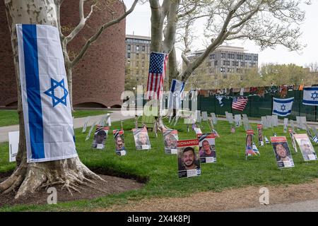 Bandiere israeliane e americane e manifesti di ostaggi israeliani siedono sul prato fuori dall'accampamento pro-Palestina del MIT durante la manifestazione. Centinaia hanno partecipato a una manifestazione pro-Israele organizzata dal capitolo del New England del Consiglio israeliano americano sui gradini dell'ingresso del MIT su Massachusetts Avenue. La manifestazione è stata una delle più grandi contro proteste tenutesi nei pressi di un accampamento universitario dell'area di Boston. Il rally era a circa 30 - 40 metri dall'accampamento pro-Palestina nel campus del MIT. La presenza della polizia era alta nella zona e sono state poste barricate metalliche per tenere i due lati da qualsiasi clashe Foto Stock