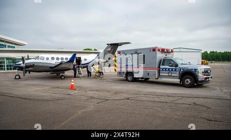 Un paziente in servizio attivo della Marina arriva all'Hampton Roads Executive Airport attraverso il progetto Caladrius prima di essere trasportato via ambulanza alla Marina Foto Stock