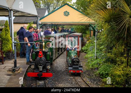 Un volontario guida la locomotiva a vapore miniaturizzata della Railway Mission e il suo tender per il carbone presso la South Downs Light Railway, Pulborough, Regno Unito Foto Stock