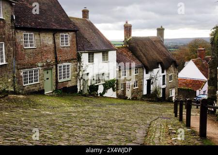 La vista lungo Gold Hill, la ripida strada acciottolata di Shaftesbury, Dorset, utilizzata per la pubblicità Hovis degli anni '1970, forse una delle più nostalgiche d'Inghilterra Foto Stock