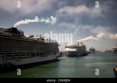 Norwegian Escape and Oasis of the Seas (Royal Caribbean International), le imbuti delle navi da crociera sprigionano fumo nel porto di Barcellona. Ossido di zolfo AN Foto Stock