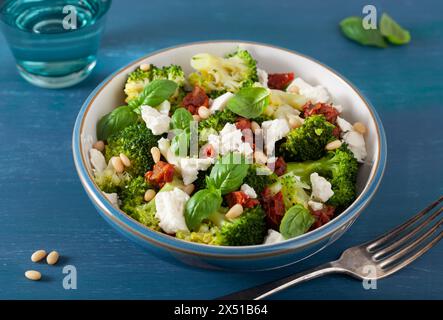 insalata di broccoli sana con formaggio feta pomodori secchi pinoli. vegetariano basso keto carb dieta Foto Stock