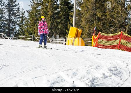 il giovane sciatore inizia a scendere da una pista da sci di medio livello. Attività ricreative attive. Stile di vita sano Foto Stock