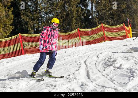 il giovane sciatore inizia a scendere da una pista da sci di medio livello. Attività ricreative attive. Stile di vita sano Foto Stock