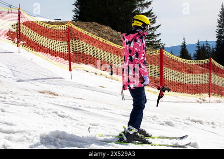 il giovane sciatore inizia a scendere da una pista da sci di medio livello. Attività ricreative attive. Stile di vita sano Foto Stock