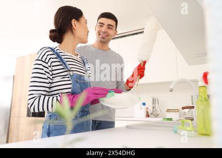 Felice giovane coppia che lava i piatti in cucina Foto Stock