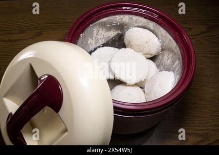 La torta di riso al vapore o Bhapa Pitha è un piatto tradizionale del Bangladesh. Spuntini invernali Vapa Pitha in una pentola calda. Foto Stock