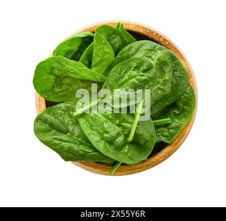 Foglie verdi di spinaci. Pile di foglie di spinaci verdi in una ciotola di legno vista dall'alto. Isolato su sfondo bianco. Elemento di progettazione per l'etichetta o il catalogo dei prodotti Foto Stock