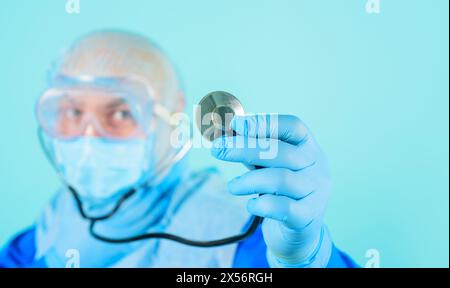 Sanità e medicina. Primo piano della mano del medico in un guanto blu con stetoscopio. Messa a fuoco selettiva. Pubblicità per ospedale o clinica. Medico di sesso maschile Foto Stock