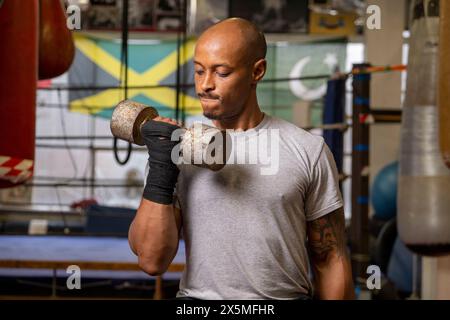 Uomo maturo che solleva manubri in palestra Foto Stock