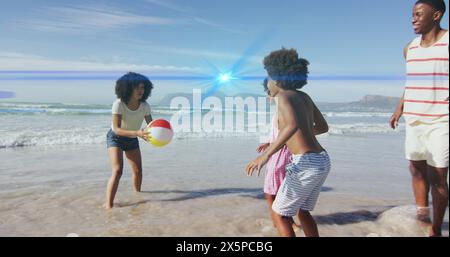 Immagine di punti luce sulla famiglia afroamericana in spiaggia Foto Stock