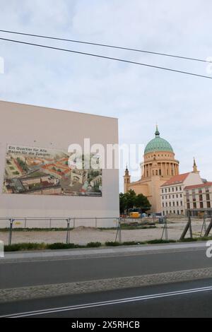 Ein großformatiges Plakate am Gebäude der Stadt- und Landesbibliothek informiert über das neue Wohn- und Geschäftsviertel am Alten Markt a Potsdam, 10. Mai 2024. Rechts die Nikolaikirche. Baustelle Alter Markt Potsdam *** Un poster di grande formato sull'edificio della Biblioteca comunale e di Stato fornisce informazioni sul nuovo quartiere residenziale e commerciale sull'Alter Markt a Potsdam, 10 maggio 2024 sulla destra, il cantiere Nikolaikirche Alter Markt Potsdam Foto Stock