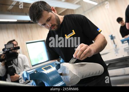 Lwiw, Ucraina. 10 maggio 2024. Un dipendente lavora su una gamba protesica durante l'inaugurazione del Centro ininterrotto per la tecnologia ortopedica, il più grande centro protesico del paese. Il viaggio è in preparazione della conferenza sulla ricostruzione dell'Ucraina, che si terrà a Berlino l'11 e il 12 giugno. Crediti: Sebastian Christoph Gollnow/dpa/Alamy Live News Foto Stock