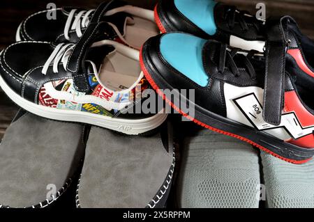 Cairo, Egitto, 1° aprile 2024: Donne, uomini scarpe casual grigie e scarpe colorate unisex per bambini, una scarpa è un oggetto di calzature destinato a proteggere e a comfort Foto Stock