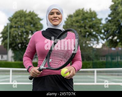 UK, Sutton, Ritratto di donna sorridente con il velo al campo da tennis Foto Stock