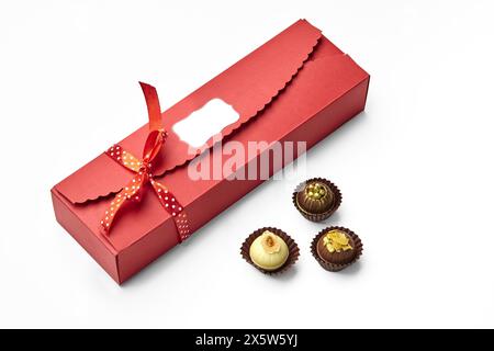 Caramelle artigianali al cioccolato racchiuse in un'elegante confezione regalo rossa Foto Stock