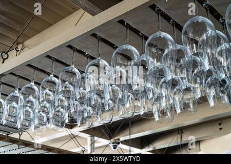 File di bicchieri da vino vuoti e puliti conservati sopra un ristorante bar a Seaside, Florida, Stati Uniti. Foto Stock