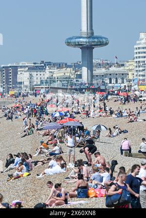 Brighton Regno Unito 12 maggio 2024 - i visitatori godono del caldo sole sulla spiaggia di Brighton, dato che le temperature si prevedono di raggiungere oggi i 27 gradi in alcune parti del Sud-Est. Accreditamento Simon Dack / Alamy Live News Foto Stock