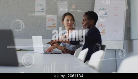 Immagine di grafici, barre di caricamento e cerchi, diverse colleghe che discutono di report su notebook Foto Stock