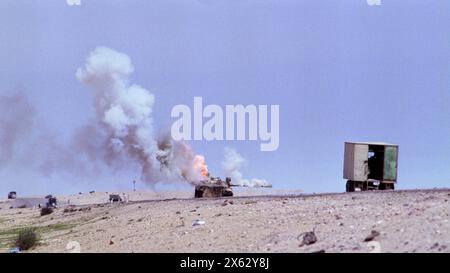 Prima guerra del Golfo: 4 marzo 1991 un carro armato iracheno T55 abbandonato spara fumo e fiamme mentre brucia sulla Route 801, la strada per um Qasr, a nord di Kuwait City. Foto Stock