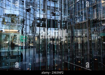 ascensori dietro una parete di vetro in un moderno edificio di uffici Foto Stock