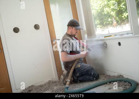 Installazione di isolamento interno in fibra di cellulosa soffiata in una casa in Scozia Foto Stock