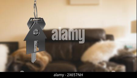 Immagine della chiave con portachiavi a forma di casa sopra l'interno del soggiorno Foto Stock