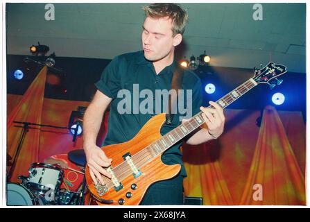 MAGNUS SVENINGSSON, YOUNG, THE CARDIGANS, 1996: Un giovane bassista Magnus Sveningsson dei Cardigans che suona un basso Hagstrom un tour del Regno Unito all'Anson Rooms dell'Università di Bristol, Inghilterra, Regno Unito il 9 novembre 1996. Foto: Rob Watkins. INFO: I Cardigans, una band svedese formata nei primi anni '90, hanno guadagnato fama internazionale con successi come "Lovefool". Il loro suono eclettico fonde elementi pop, rock e indie, caratterizzati dalla caratteristica voce di Nina Persson e dalla propensione per melodie accattivanti. Foto Stock