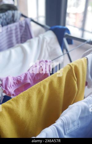 primo piano di un bucato bagnato appeso e asciugato su un'asciugatrice per stanza metallica, Foto Stock