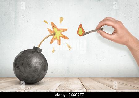 Immagine di una bomba a sfera nera su un pavimento di legno Foto Stock