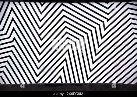 Linee geometriche astratte e ricorrenti nere spesse tracciate su una superficie bianca Foto Stock