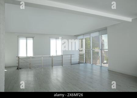 Grande sala vuota con finestre e ringhiere Foto Stock