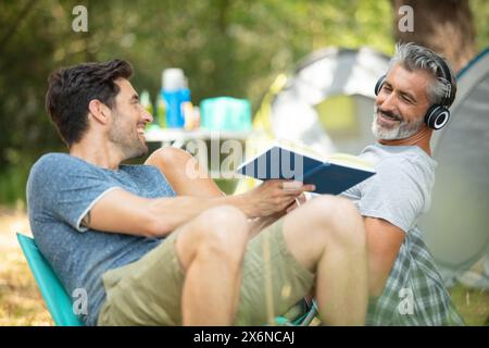 gli amici si rilassano fuori tende in vacanza in campeggio Foto Stock